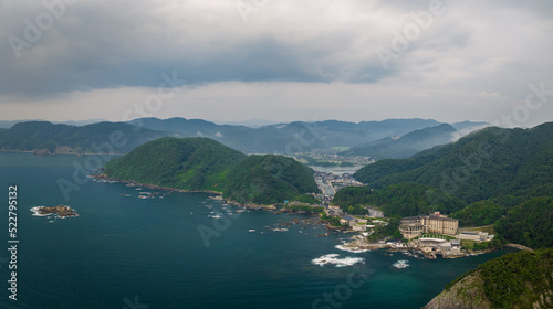 Panoramic view of large hotel in mountainous coastal region in early morning