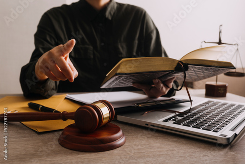 Male lawyer working with contract papers and wooden gavel on tabel in courtroom. justice and law ,attorney, court judge, concept.