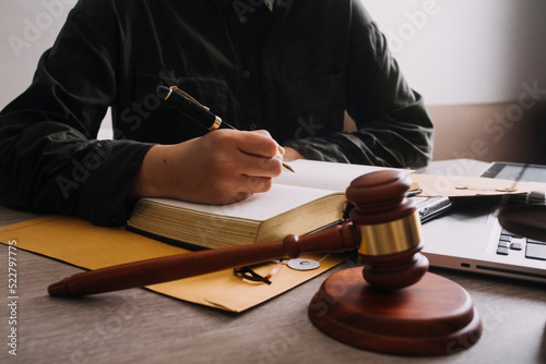 Male lawyer working with contract papers and wooden gavel on tabel in courtroom. justice and law ,attorney, court judge, concept.