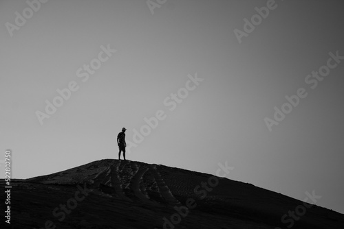 man on the top of a dune, man in a dune, black and white 
