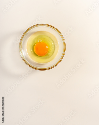 Raw eggs. Close up. flat lay raw eggs yolk in bowl. Isolated broken white background.