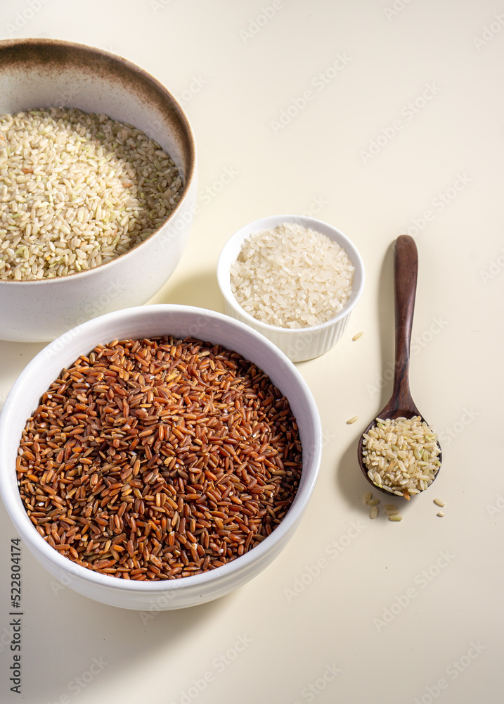 Uncooked rice assortment in bowl on white background. Top view. Uncooked rice assortment in bowl on white background. Top view.