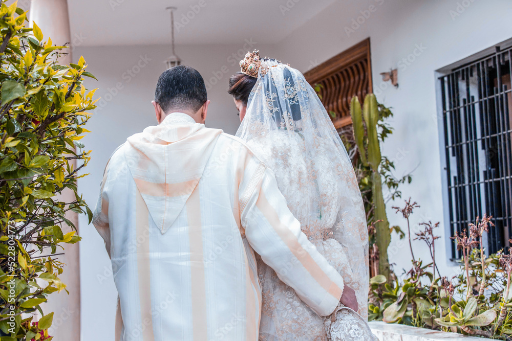 Moroccan groom in the djellaba holding his bride's caftan. Wedding ...