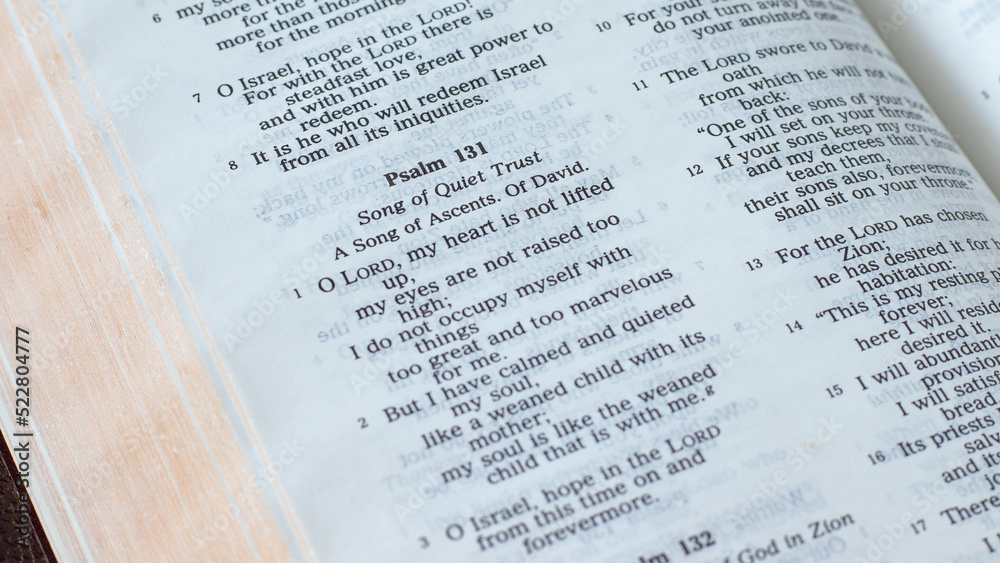 Obraz premium Psalm 131 in an open Holy Bible Book. A closeup. Old testament Scripture, trust in God Scripture verse.