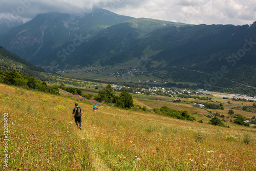 People walking into the town of Tsaldashi, during the trek from the town of Mestia to Ushguli, in Geogia. photo