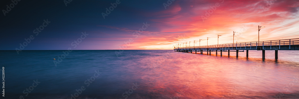 Amazing sunrise over the pier in Mechelinki