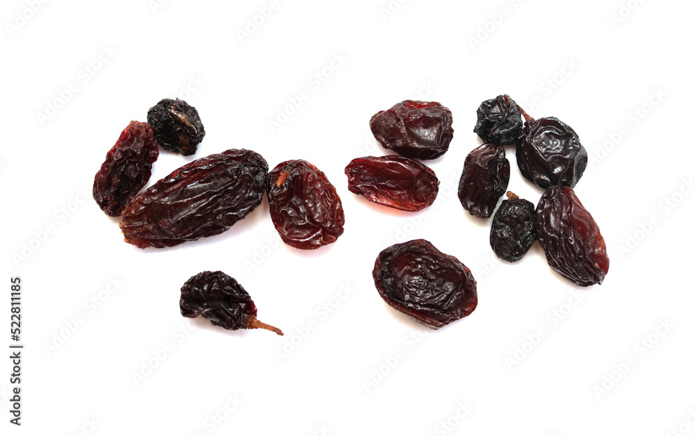 Dried dark raisins on a white background. Dried dark raisins on a white background.