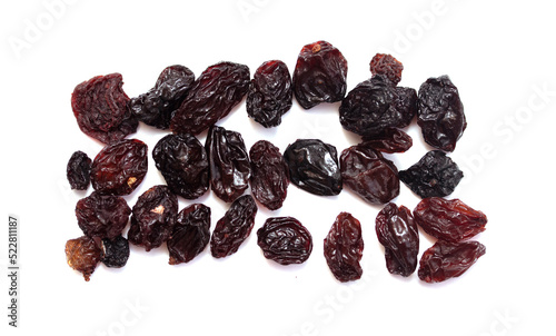 Dried dark raisins on a white background.