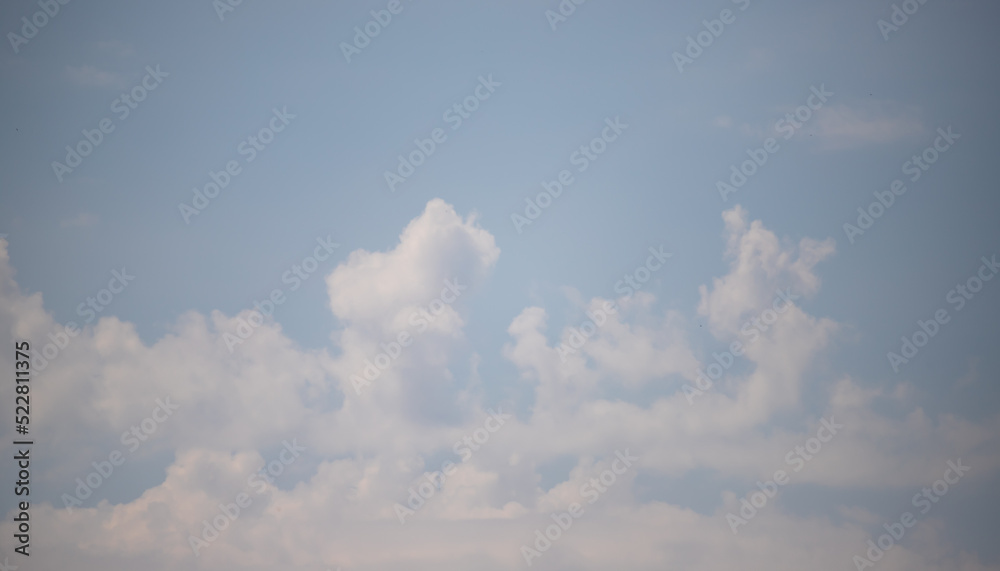 Light blue sky and white clouds. Peaceful sky background. Light blue sky and white clouds. Peaceful sky background.