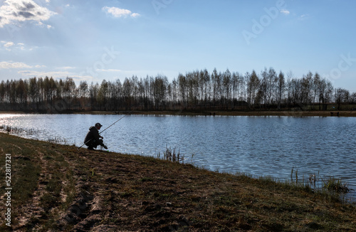 Calm landscape with fisherman fishing at water lake river. High quality photo