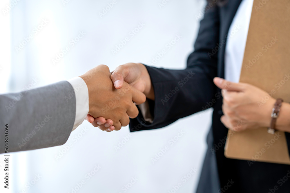 Business people shaking hands after joining a good business dealing in the office. Collaborative teamwork.