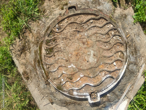 Valokuva Iron soviet manhole with concrete base