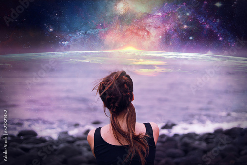 Young girl with braids observing the earth and the galaxy from space