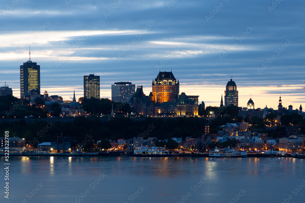 The Quebec City old town’s skyline seen during a summer night, with the St. Lawrence River in the foreground, Levis, Quebec, Canada