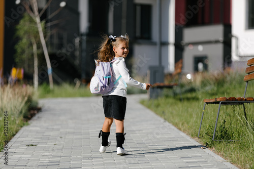 a little girl goes to school through the park along the path. distance education concept. schoolgirl returning home from school  © Ruslan Ivantsov