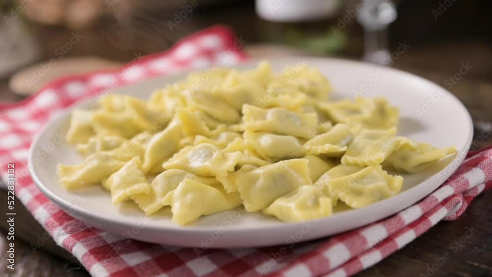 Plin del Piemonte. Small ravioli del plin typical Piedmontese filled pasta from the Langhe in Italy seasoned. Hot steam coming from the plate. High quality FullHD footage Plin del Piemonte. Small ravioli del plin typical Piedmontese filled pasta from the Langhe in Italy seasoned. Hot steam coming from the plate. High quality FullHD footage