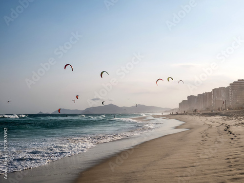 Kitesurfers catch the evening breeze on the Barra da Tijuca beach in Rio