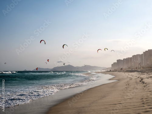 Kitesurfers catch the evening breeze on the Barra da Tijuca beach in Rio photo