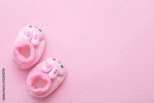 booties in the shape of a hare on a pink background with copy space © Елена Белоусова