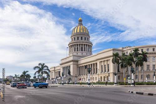 HAVANA,CUBA - JANUARY 11, 2021 : Street scene with classic convertible cars and the famous Capitol of Havana © Picturellarious