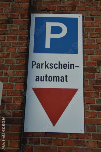 parking ticket machine sign on a brick wall