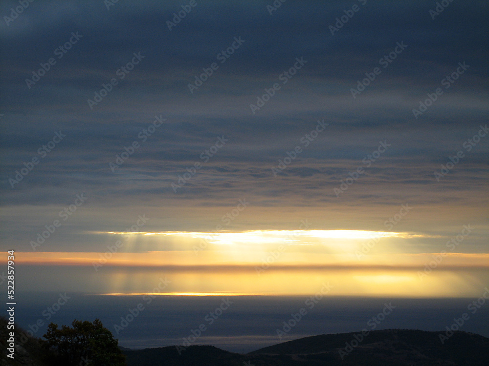 Rays of sun breaks through a gap in the cloud Rays of sun breaks through a gap in the cloud
