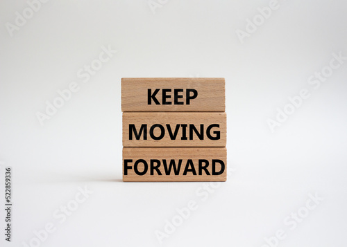 Keep moving forward symbol. Concept words keep moving forward on wooden blocks. Beautiful white background. Business and keep moving forward concept. Copy space.