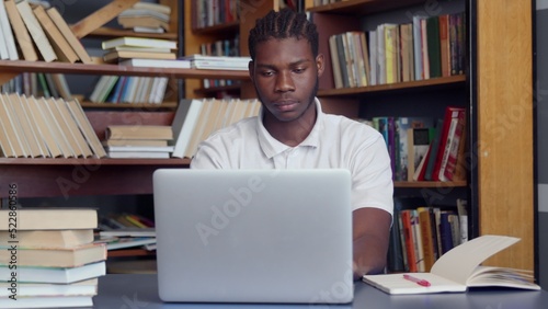 4K. An Afro-American studies in the library. The student prepares for exams, writes notes.