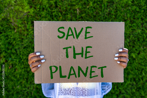 woman holding placard poster save the planet