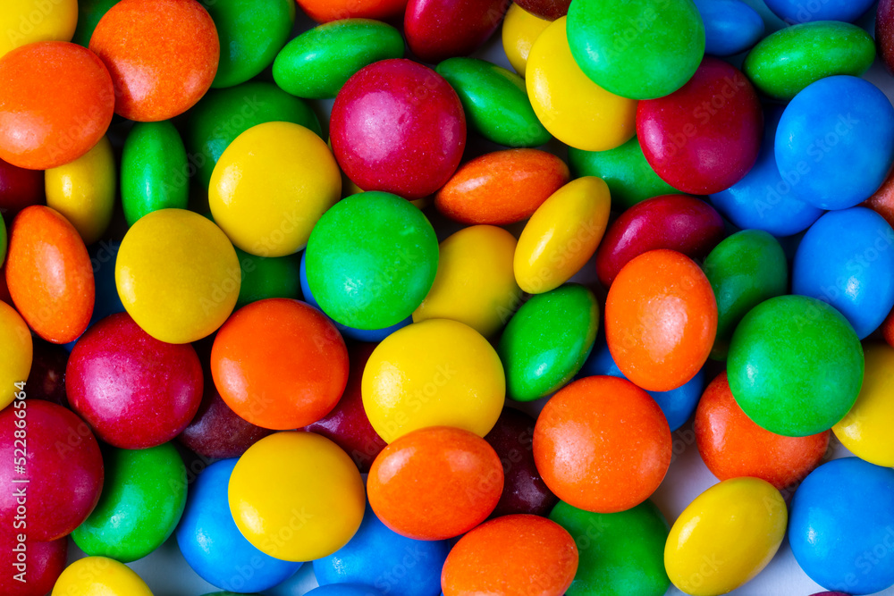 A Pile of Rainbow Colored Candy Coated Chocolate Buttons Isolated A Pile of Rainbow Colored Candy Coated Chocolate Buttons Isolated