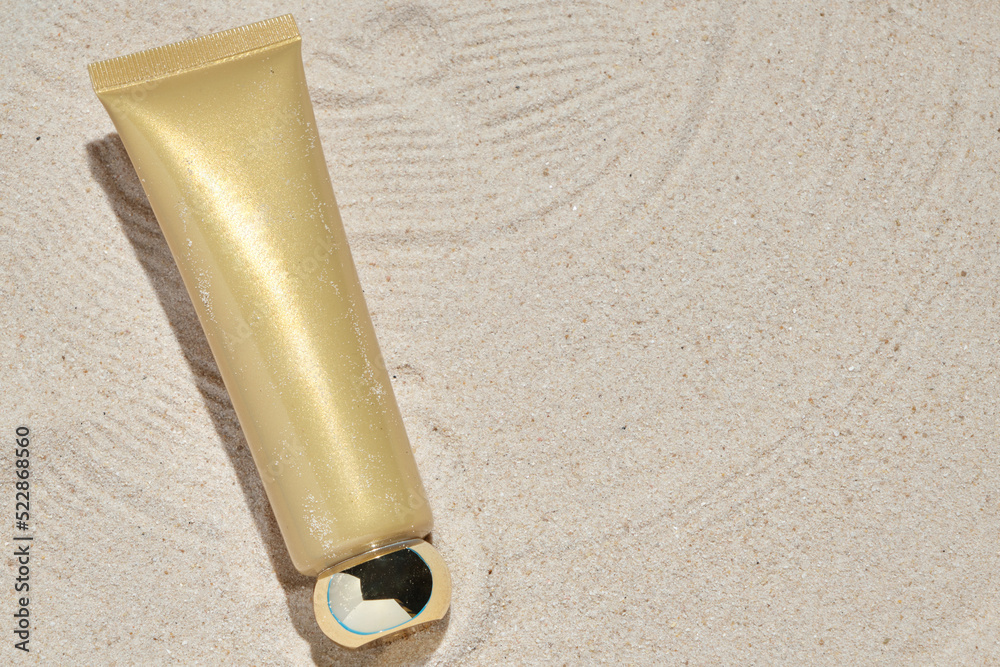 cosmetic product in tube on nature background with sand. Essential cream for moisturizing body skin, face care, sunblock. mockup of beauty fashion cosmetic bottle dropper product with skincare.