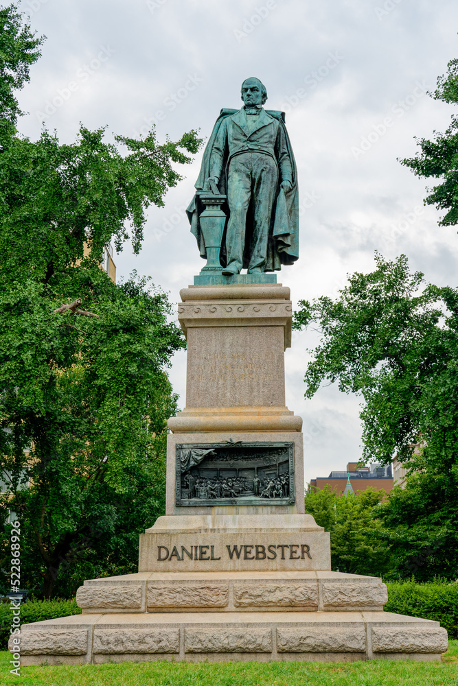 Daniel Webster memorial includes a statue sculpted in 1898 by Gaetano Trentanove. The pedestal dedicated in 1900 includes bronze bas-relief panels.