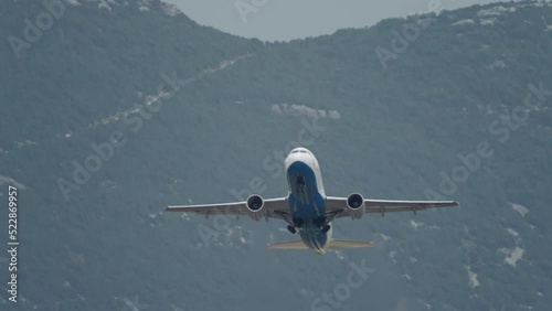 Slow-motion video of an airplane taking off in a mountain landscape. The plane flies into the sky. High quality 4k footage photo
