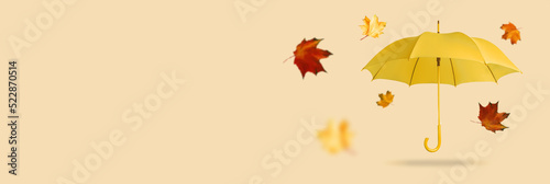 Yellow umbrella with leaves on an orange background