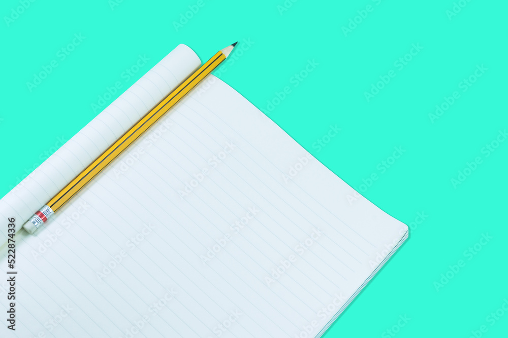 Notebook with pencil isolate on green background,for art education background Notebook with pencil isolate on green background,for art education background
