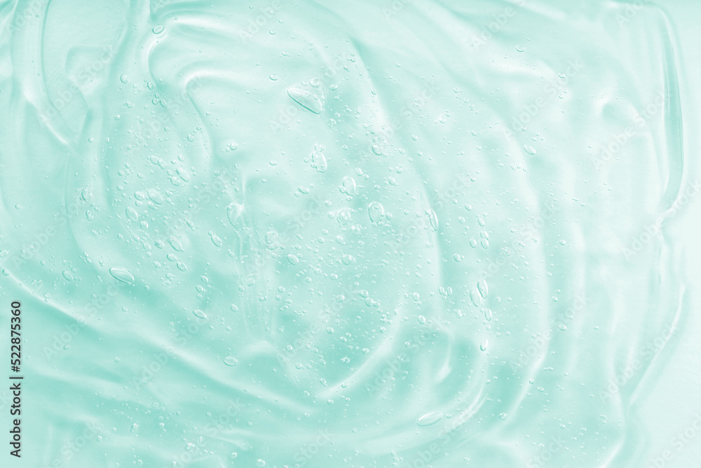 Hyaluronic acid clear serum sample. Cosmetic gel texture with bubbles background. Liquid green oil smudge. The concept of natural cosmetics. Skincare moisturizing product. Close-up, macro. Hyaluronic acid clear serum sample. Cosmetic gel texture with bubbles background. Liquid green oil smudge. The concept of natural cosmetics. Skincare moisturizing product. Close-up, macro.