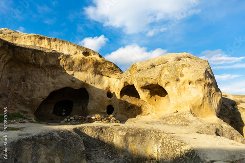 View of rock-hewn caves of ancient ruined Uplistsikhe city near Gori town. Historical and archaeological sights of Georgia