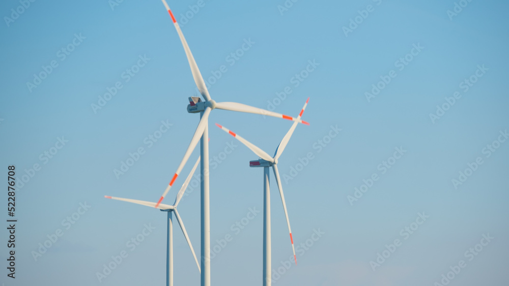 Wind energy.Windmills on a blue sky background.Wind generators. Natural energy.Alternative energy sources.Environmentally friendly natural energy source. 