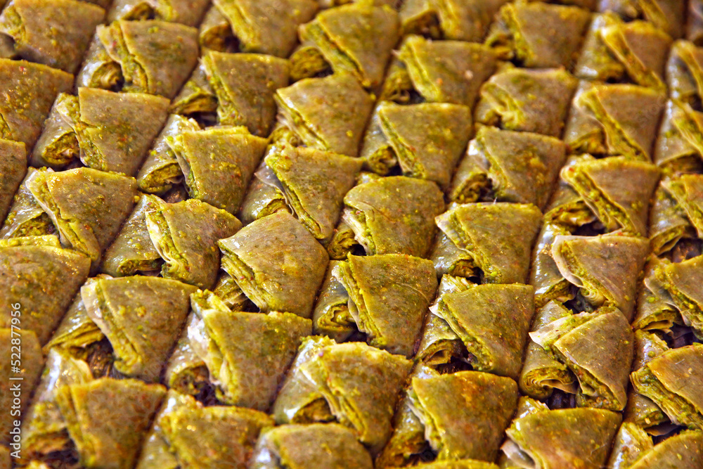 Close-up traditional Turkish baklava (sweet dessert made of thin pastry, nuts and honey)