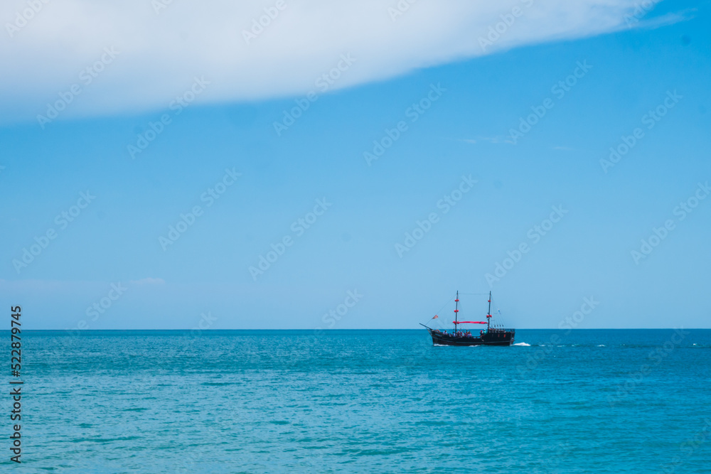 Two mast schooner under sails on the sea. Cross processed. High quality photo