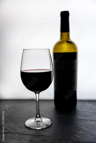 Wine glass with wine bottle and white background