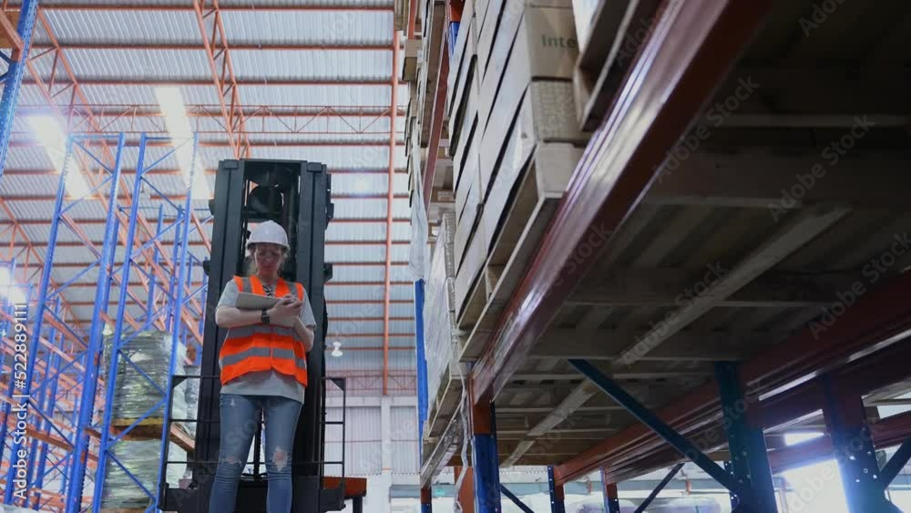 Business concept of 4k Resolution. An employee is checking the goods with a tablet in the warehouse. Business concept of 4k Resolution. An employee is checking the goods with a tablet in the warehouse.