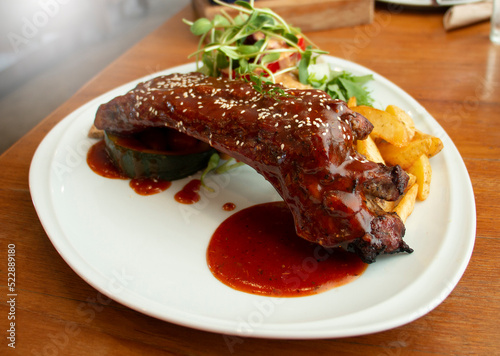 barbeque spareribs with salad and fries