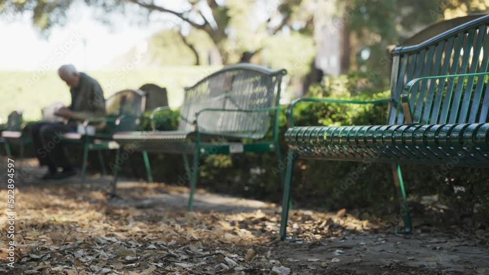 Old man sitting on a bench in the park Old man sitting on a bench in the park