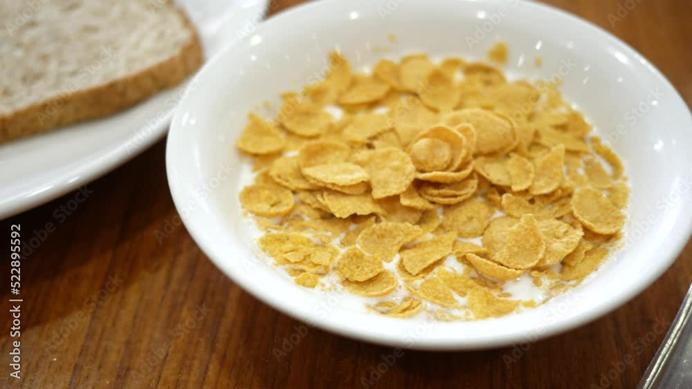 close up of corn flakes in a bowl for breakfast close up of corn flakes in a bowl for breakfast