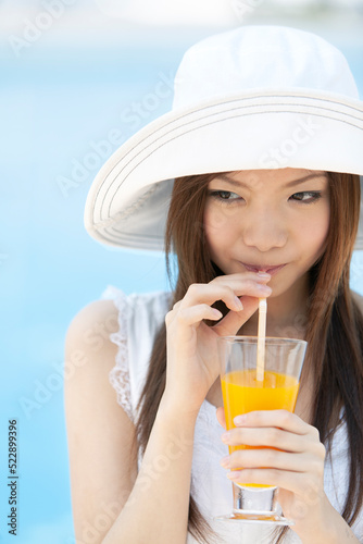 オレンジジュースを飲む女性