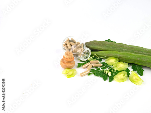 Moringa oleifera pods, calsula powder, green leaf and flower isolated on white background.