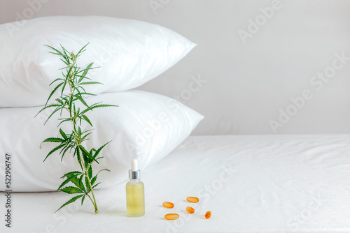 Melotonin production, pills, capsules and cbd oil on the bed. Concept sleep disorder. beat insomnia and restore sleeping routine. photo