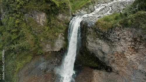 Water Cascading Down The Cliff, Manto de la Novia Waterfall In Baños, Ecuador - aerial drone shot