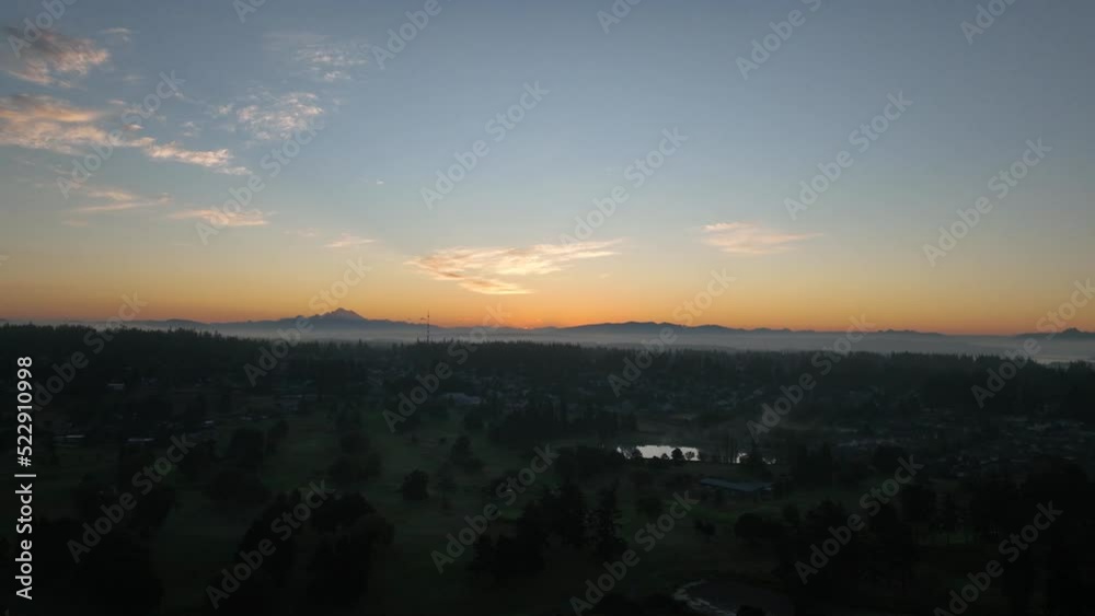 Aerial shot of the sun rising over Mount Baker from Whidbey Island. Aerial shot of the sun rising over Mount Baker from Whidbey Island.